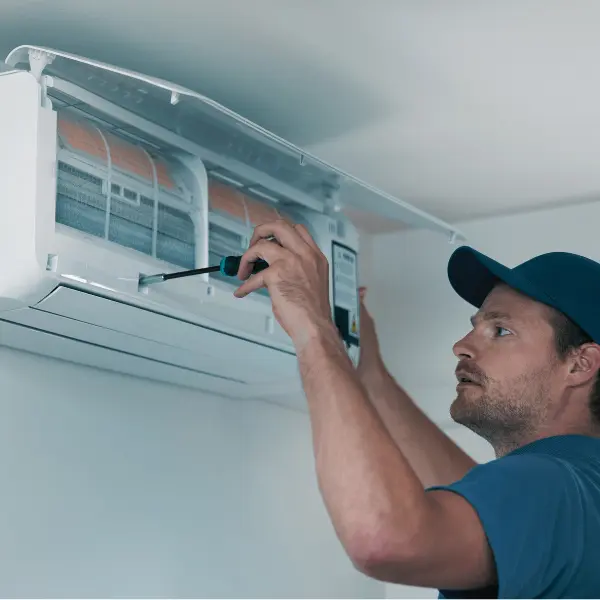 technician installing an air conditioner