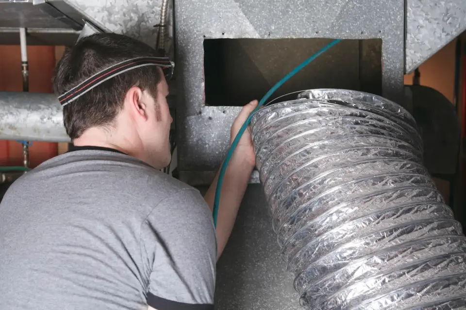 hvac worker repairing an ac unit